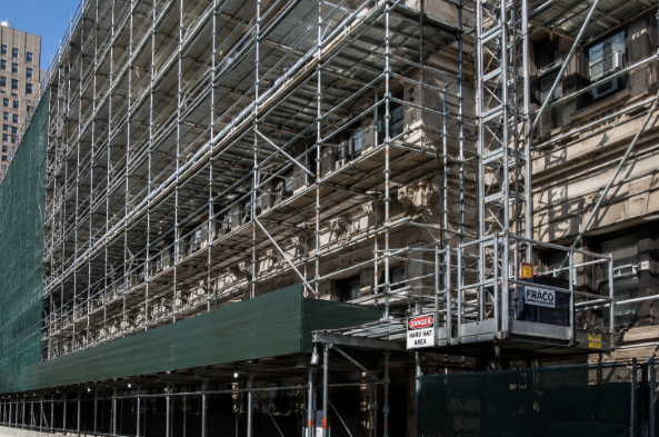 Full-perimeter sidewalk shed and suspended scaffolding installation on NYC building by Nexus Construction Group Inc